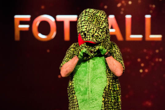 Bjarne Berntsen, coach of Viking, in a dinosaur costume