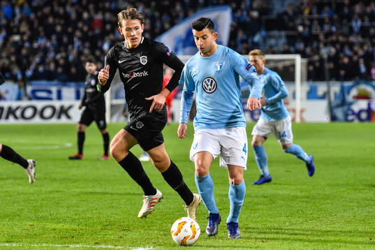 Sander Berge of Genk and Behrang Safari of Malmö FF