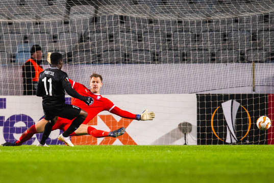 Joseph Paintsil of Genk scores 0-2 behind goalkeeper Johan
