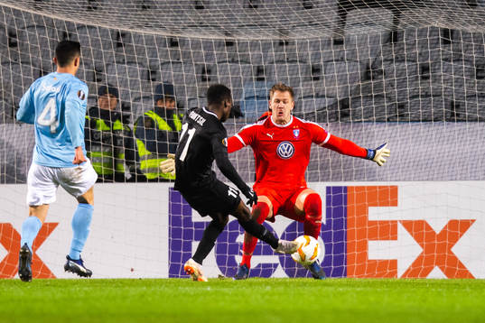 Joseph Paintsil of Genk scores 0-2 behind goalkeeper Johan