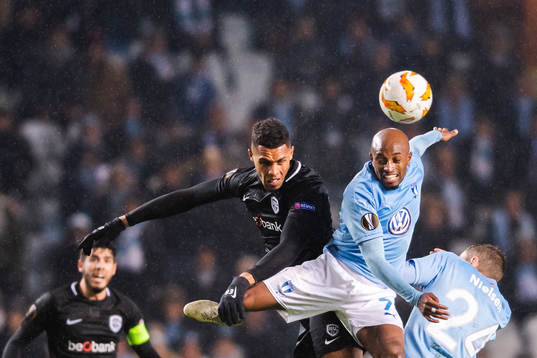 Zinho Gano of Genk in a duel with Fouad Bachirou of Malmö
