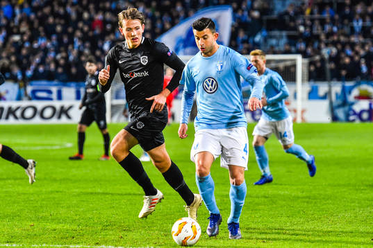 Sander Berge of Genk and Behrang Safari of Malmö FF