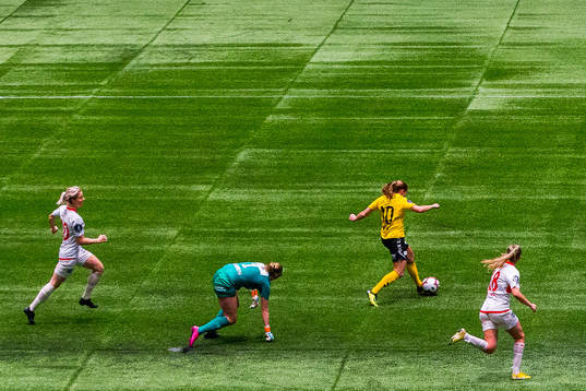 Guro Reiten of LSK Kvinner runs past Ingrid Marie Karlsen