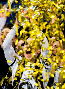 Mike Jensen of Rosenborg lifts the trophy in front of