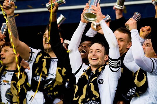 Mike Jensen of Rosenborg lifts the trophy