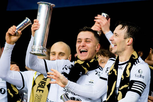 Jonathan Levi of Rosenborg lifts the trophy with teammate