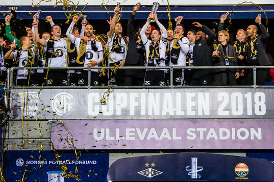 Mike Jensen of Rosenborg lifts the trophy