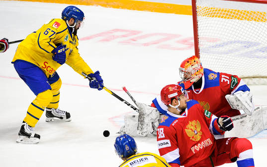 Sweden\s LinusFroberg, left, tries to score against