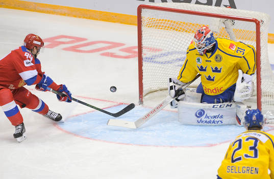 Sweden's goalie Lars Johansson, right, makes a save against