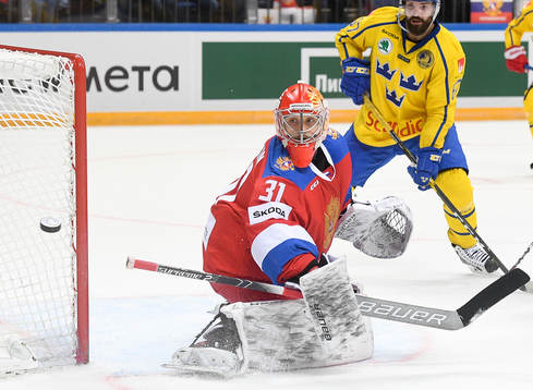 Sweden's Linus Froberg, right, watches Russia's goalie Ilya