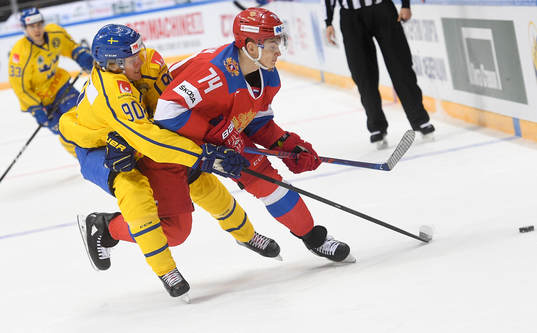 Sweden's Jesper Boqvist, left, struggles for a puck with