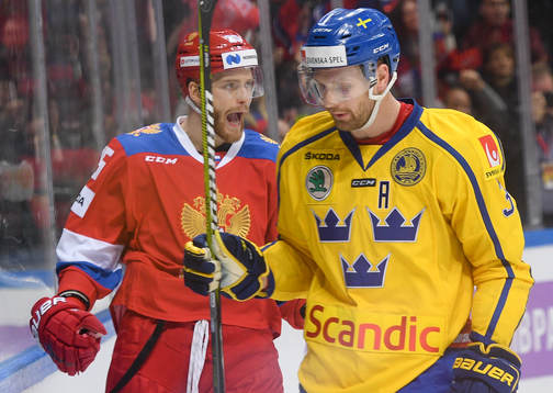 Russia's Mikhail Grigorenko, left, celebrates his goal