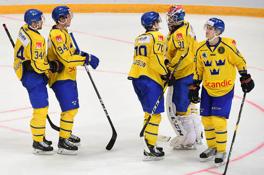 Sweden's players comfort their goalie Lars Johansson, 2nd