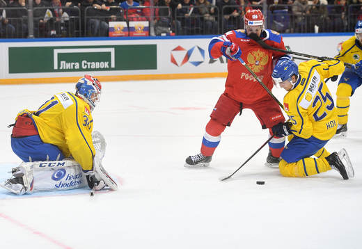 Sweden's goalie Lars Johansson, left, and Philip Holv,