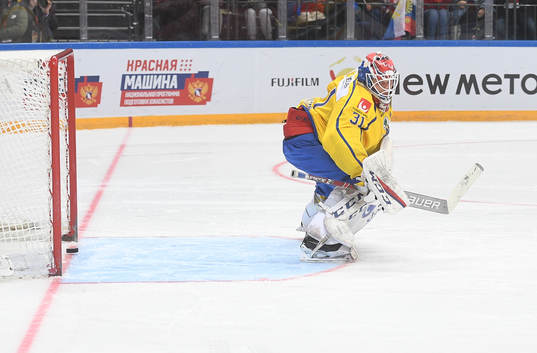Sweden's goalie Lars Johansson misses a shot by Russia's