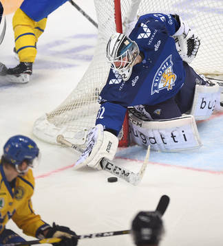 Finland's goalie Rasmus Tirronen makes a save