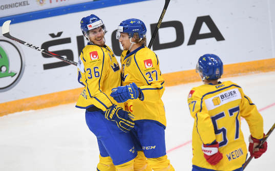 Sweden's Emil Larsson, left, celebrates his goal with John