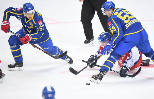 Sweden's Anton Wedin, left, and Linus Johansson control a
