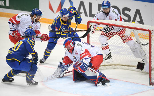 Sweden's Michael Lindqvist, centre top, scores team's