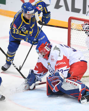 Sweden's Michael Lindqvist, top, scores team's victory goal