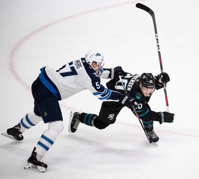 Tyler Myers of Winnipeg Jets tackles Marcus Sörensen of