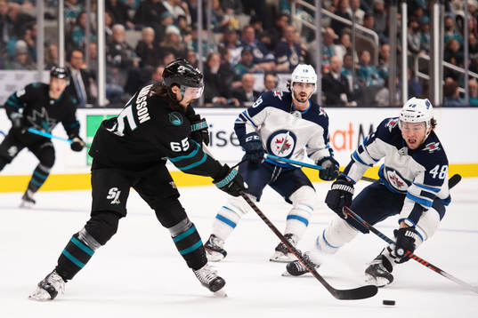 Erik Karlsson of San Jose Sharks passes the puck past