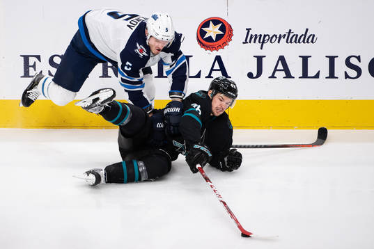 Dmitry Kulikov of Winnipeg Jets and Tomas Hertl of San Jose