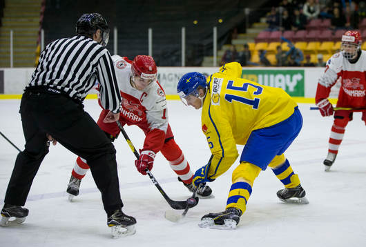 Sweden forward Oskar Bäck (15)  faces off against Denmark