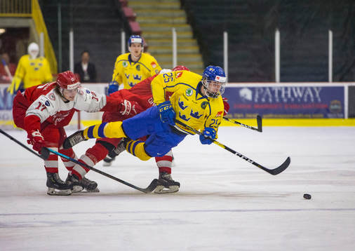 Sweden defenceman Philip Broberg (25)  gets tripped up by