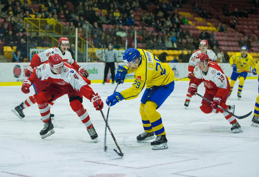 Denmark defenceman Lasse Mortensen (4)  checks Sweden