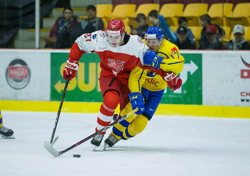 Sweden forward Filip Sveningsson (17)  checks Denmark