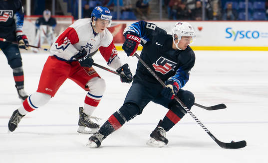Jack Drury #19 of the United States tries to break away