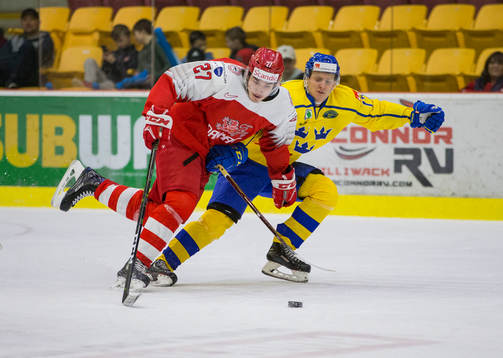 Sweden forward Filip Sveningsson (17)  checks Denmark