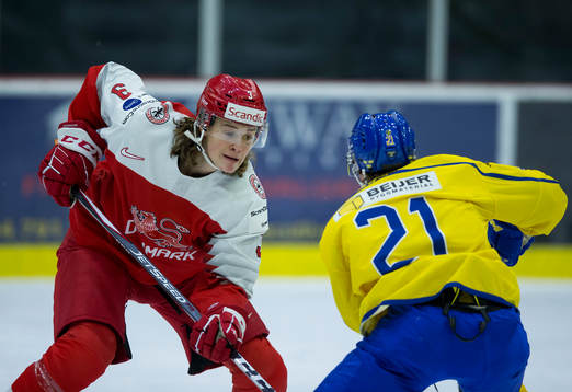 Denmark defenceman Malte Setkov (3) checks Sweden forward