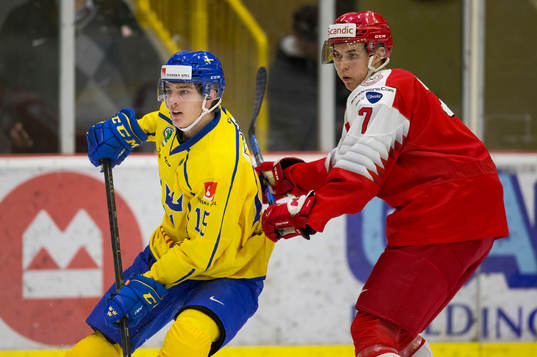 Sweden forward Oskar Bäck (15) battles with Denmark