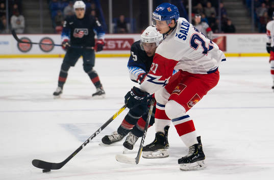 Radim Salda #21 of the Czech Republic tries to clear the