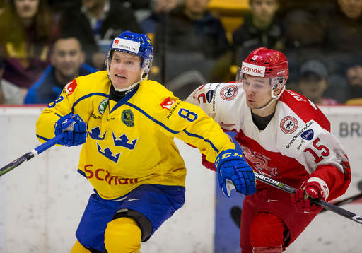 Sweden defenceman Rasmus Sandin (8)  battles with Denmark