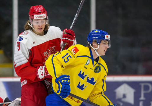 Denmark defenceman Malte Setkov (3)  battles with Sweden