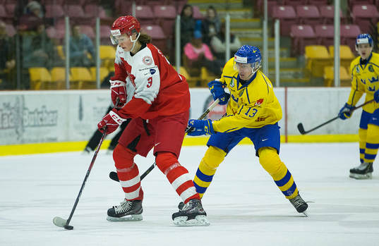 Sweden forward Johan Södergran (13)  checks Denmark