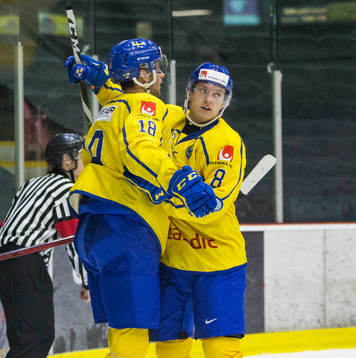 Sweden forward Jacob Olofsson (18) and  defenceman Rasmus