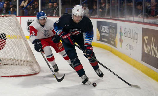 Ryan Poehling #11 of the United States tries to break away