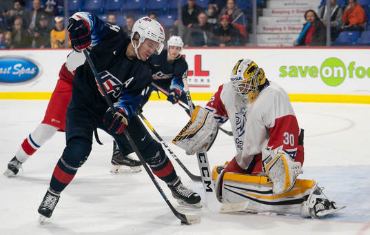 Josh Norris #14 of the United States (left) tries to make a