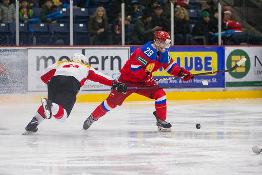 Switzerland defenceman Tim Berni (21)  checks Russia
