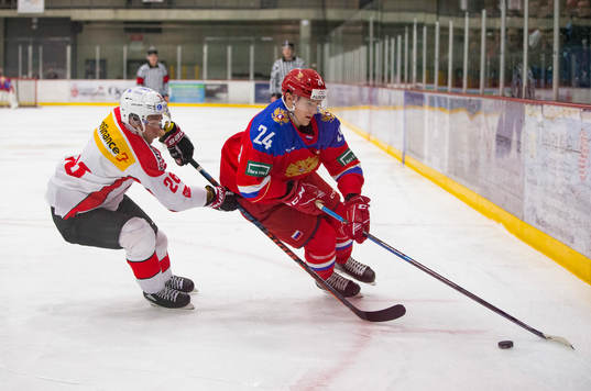 Switzerland defenceman David Aebischer (26)  checks Russia