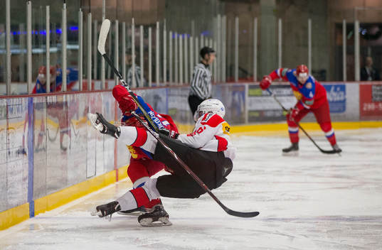 Switzerland defenceman Nico Gross (16)  checks Russia