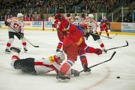 Switzerland defenceman Davyd Barandun (19)  checks Russia
