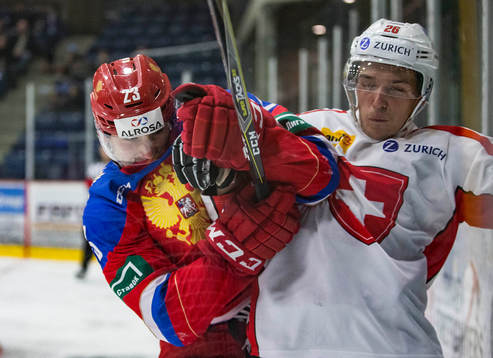 Russia forward Ivan Muranov (23)  checks Switzerland