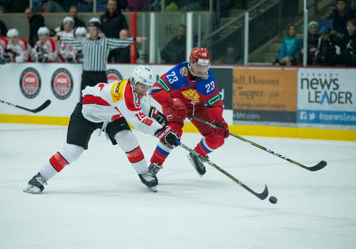 Switzerland defenceman Davyd Barandun (19)  checks Russia
