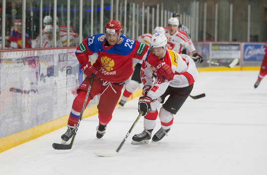 Switzerland defenceman Nico Gross (16)  checks Russia