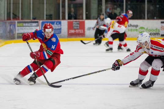 Switzerland defenceman Nico Gross (16)  checks Russia